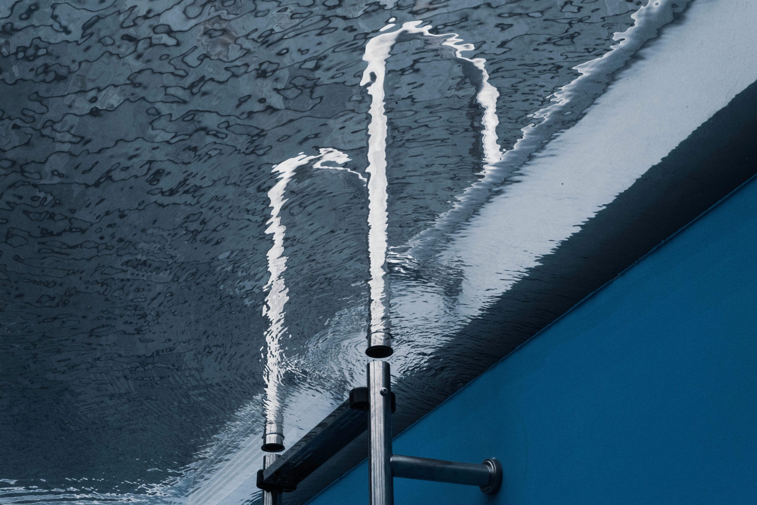 Creative water reflection with metal pipe in a swimming pool.